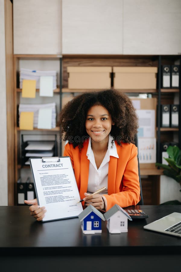 Young Real Estate Agent Worker Working with Laptop and Tablet at Table