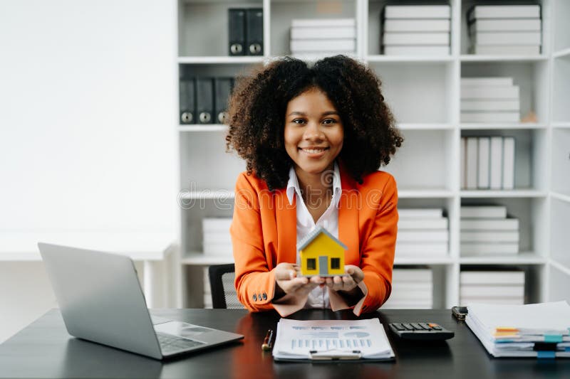 Young Real Estate Agent Worker Working with Laptop and Tablet at Table