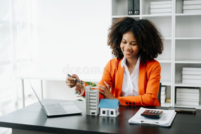 Young Real Estate Agent Worker Working with Laptop and Tablet at Table