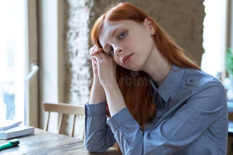Young red-haired girl student woman preparing for exams at the c stock photo Young red-haired girl student woman preparing for exams at the c stock photo