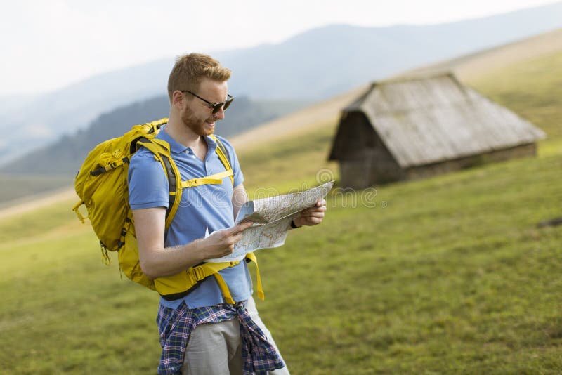 Young Redhair Man on Mountain Hiking Holding a Map Stock Photo - Image ...