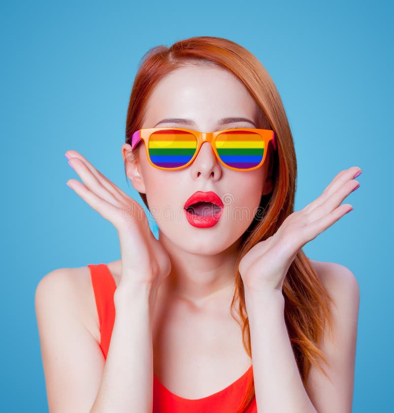 Young redhead girl in rainbow glasses