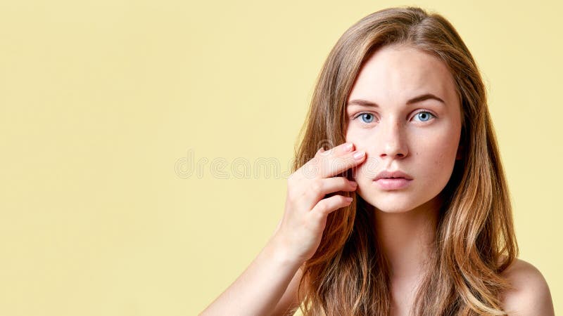 Young redhead teenager with self issues looking into mirror. Girl with low self esteem checking her skin. stock images Young redhead teenager with self issues looking into mirror. Girl with low self esteem checking her skin. stock images