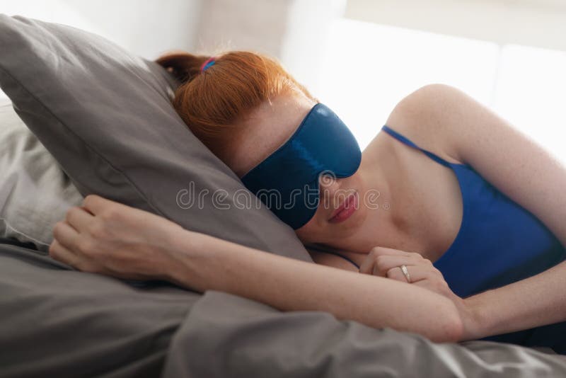 Woman In Bed Sleeping With Sleep Mask On Eyes royalty free stock photos Woman In Bed Sleeping With Sleep Mask On Eyes royalty free stock photos
