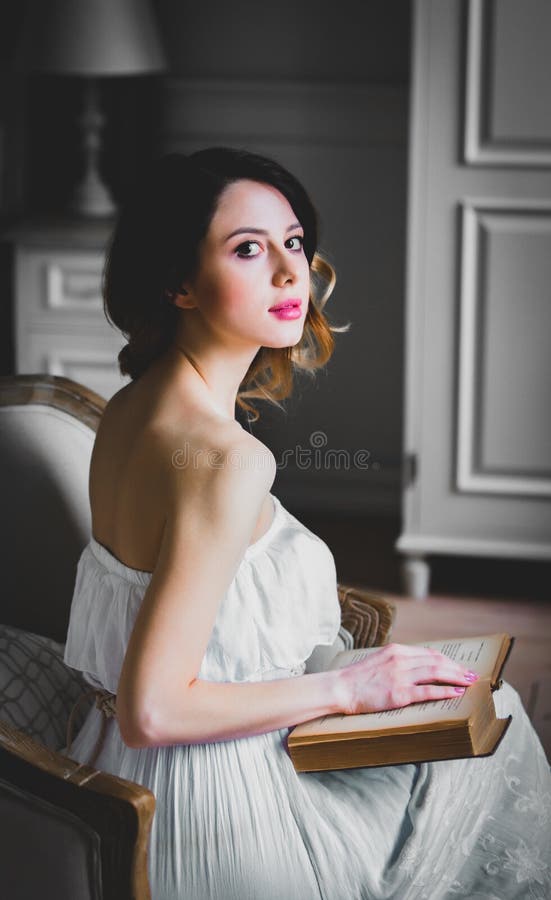 Young redhead woman covered by a book - a Royalty Free Stock Photo