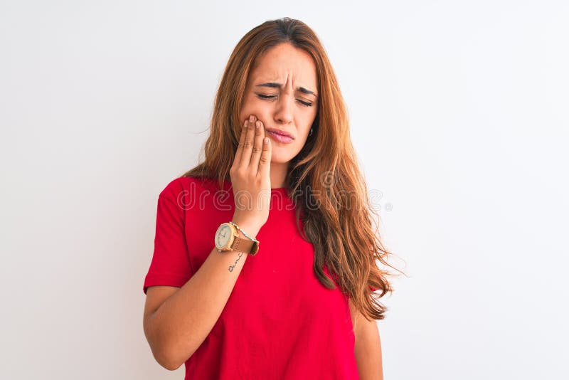 Young redhead woman wearing red casual t-shirt stading over white isolated background touching mouth with hand with painful