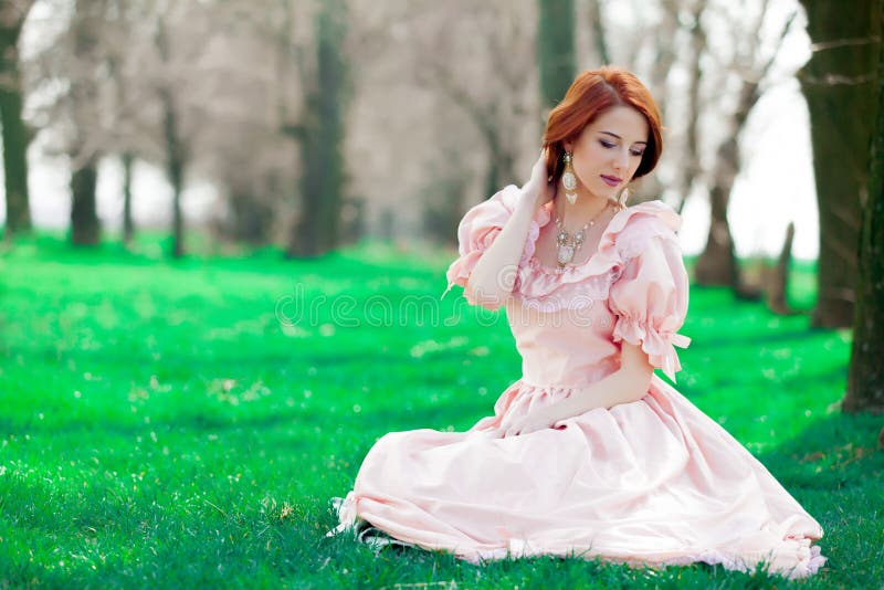 Young redheadd girl in victorian style dress