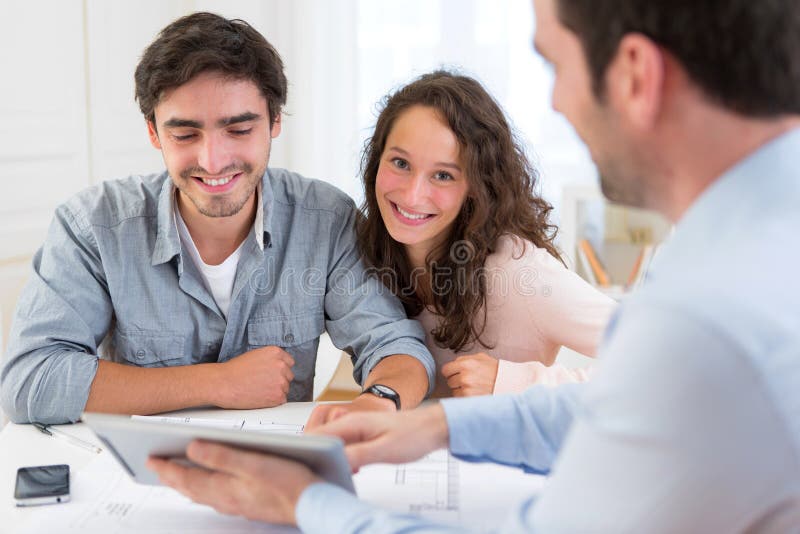 Young relaxed couple meeting a real estate agent stock image Young relaxed couple meeting a real estate agent stock image