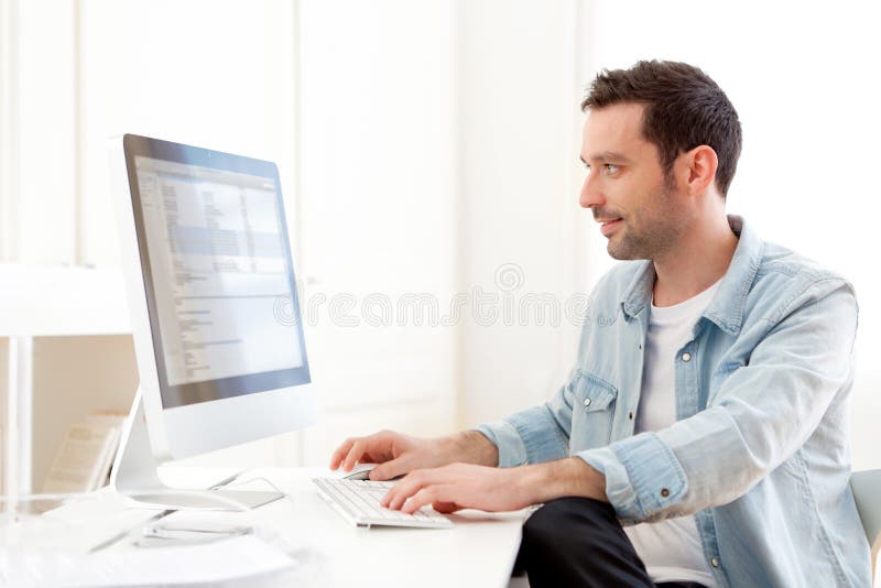 Young relaxed man using computer royalty free stock images