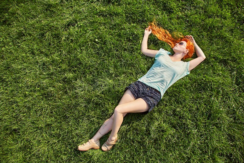 Young Relaxing Redhead Girl Lying On The Grass Woman Relaxation
