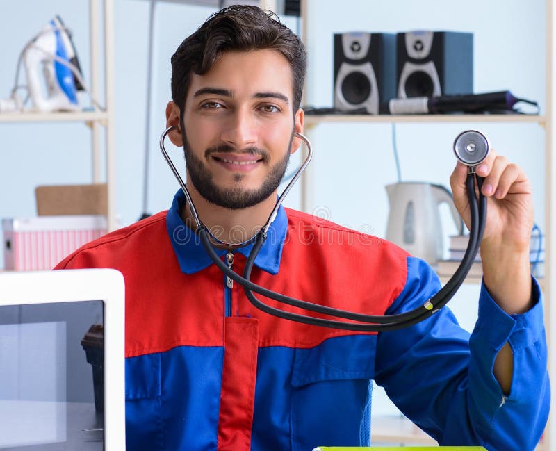 Young repairman fixing and repairing microwave oven stock images Young repairman fixing and repairing microwave oven stock images