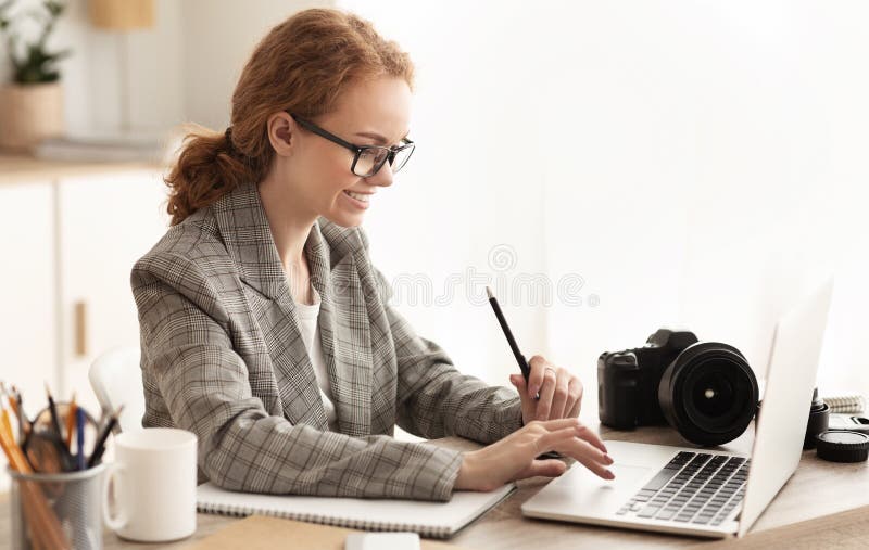 Young reporter transfering image data from camera to laptop stock images