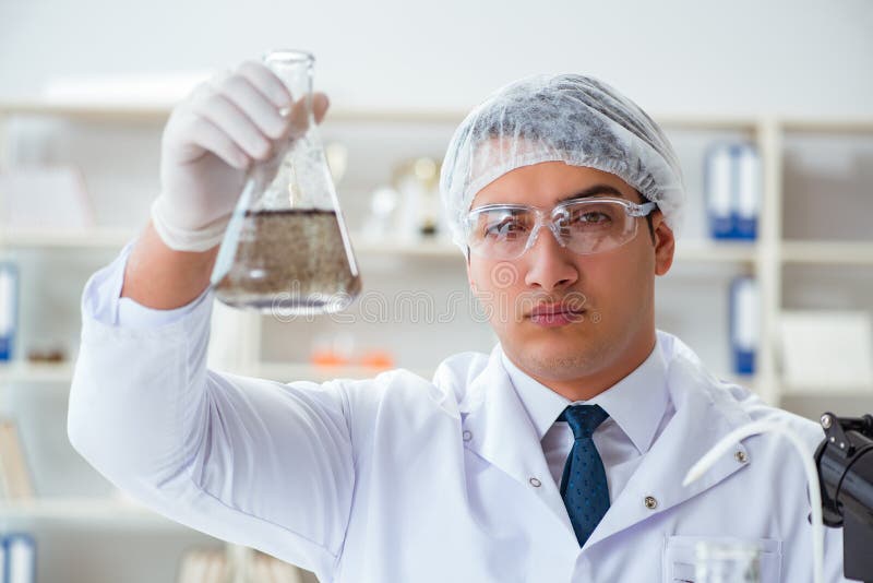 Young Researcher Scientist Doing a Water Test Contamination Expe Stock