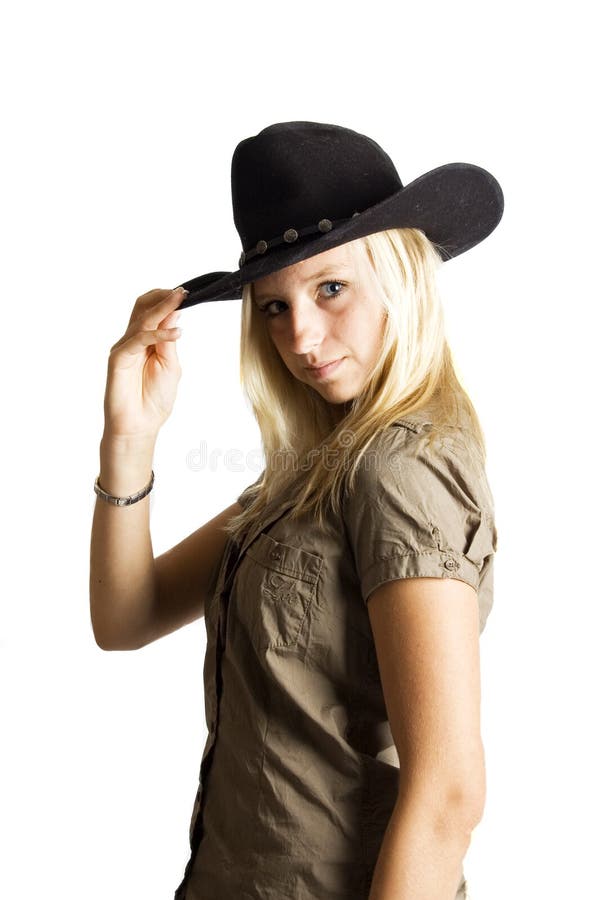 Young rodeo cowgirl holding cowboy hat