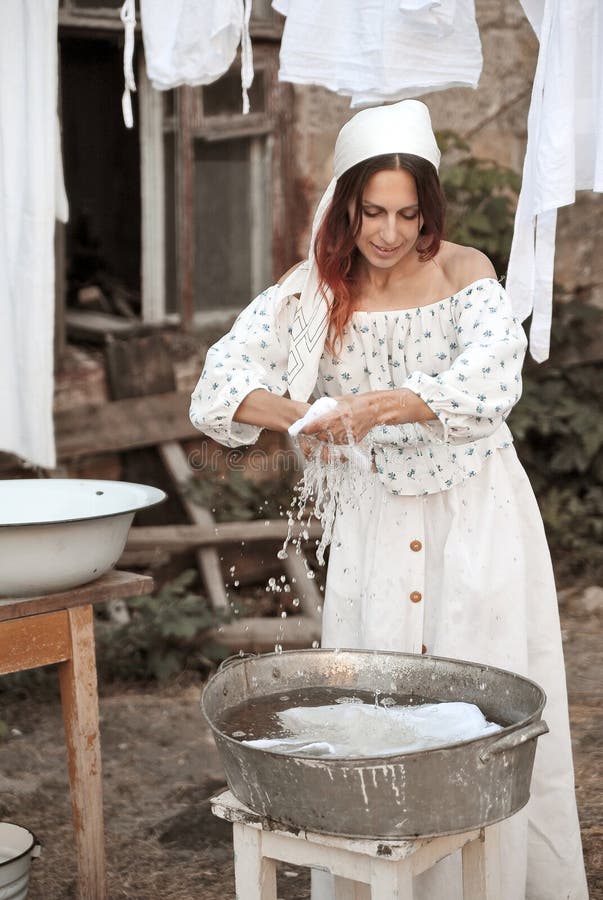 Young rural woman washing clothes in a washbasin