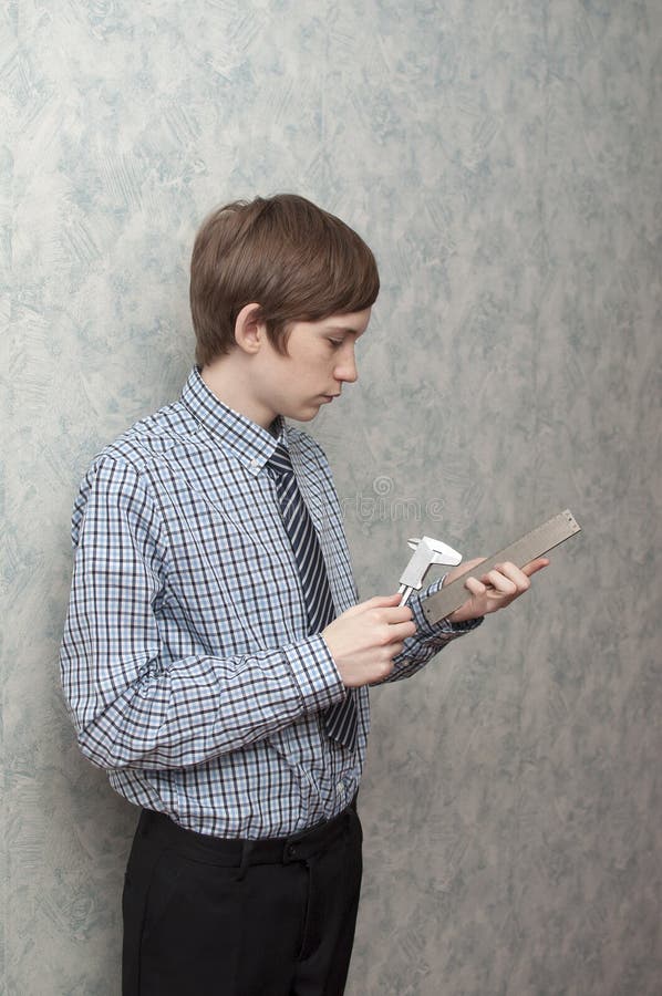 The Young Russian Guy Holds a Caliper in Hand Stock Image Image of