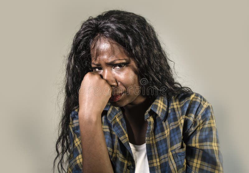 Young sad and depressed black African American woman crying anxious and overwhelmed feeling sick and stressed on studio b. Ackground suffering depression problem royalty free stock photo