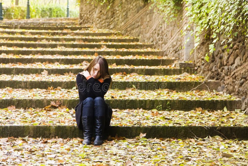 Young sad woman in steps