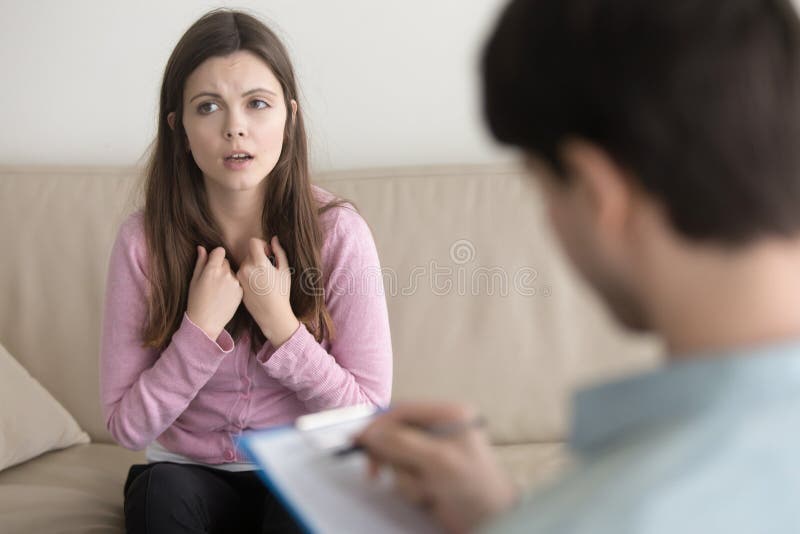 Young sad woman telling about her problem to male psychotherapis stock images Young sad woman telling about her problem to male psychotherapis stock images
