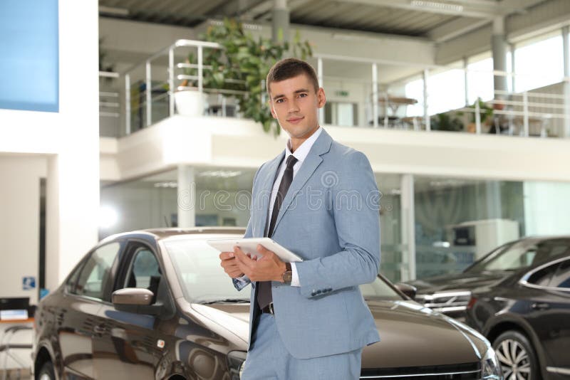 Car Salesman with Tablet and Blurred Family Near Auto Stock Image