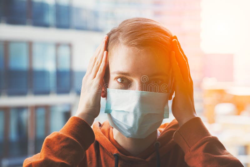 Young scared woman wearing surgical mask because of viruses and air pollution in the city royalty free stock image Young scared woman wearing surgical mask because of viruses and air pollution in the city royalty free stock image
