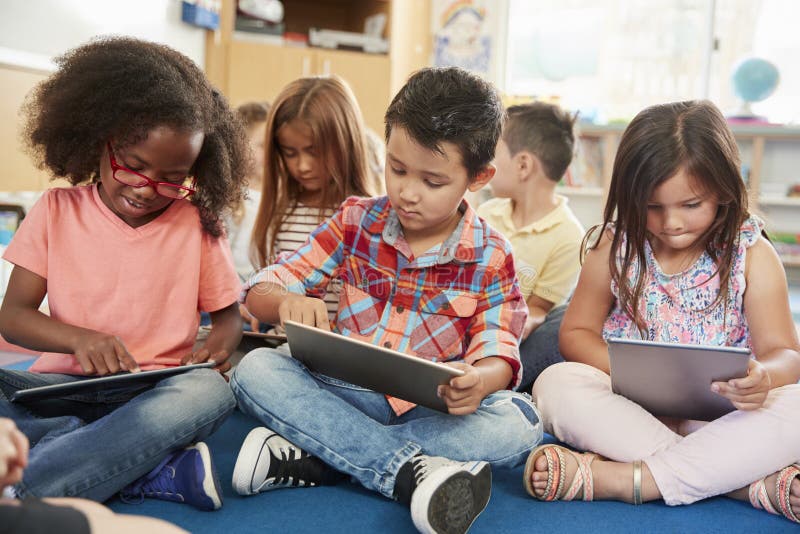 Young school kids in class using tablet computers, close up royalty free stock image