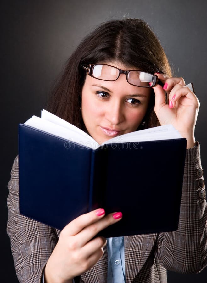 Young school teacher reading a book