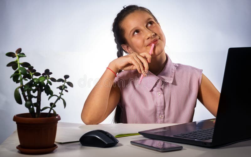 A Young Schoolgirl Does Her Homework In Connection With The Quarantine 