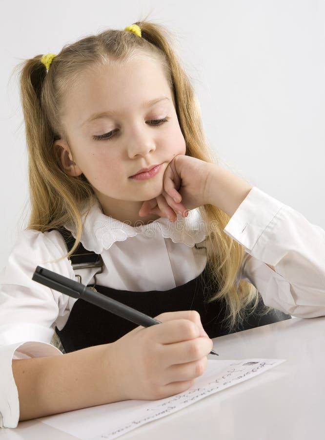 Young schoolgirl writing in a classroom