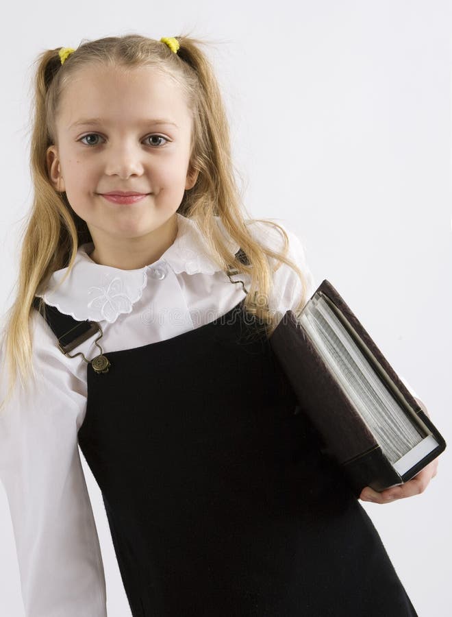 Young schoolgirl writing in a classroom