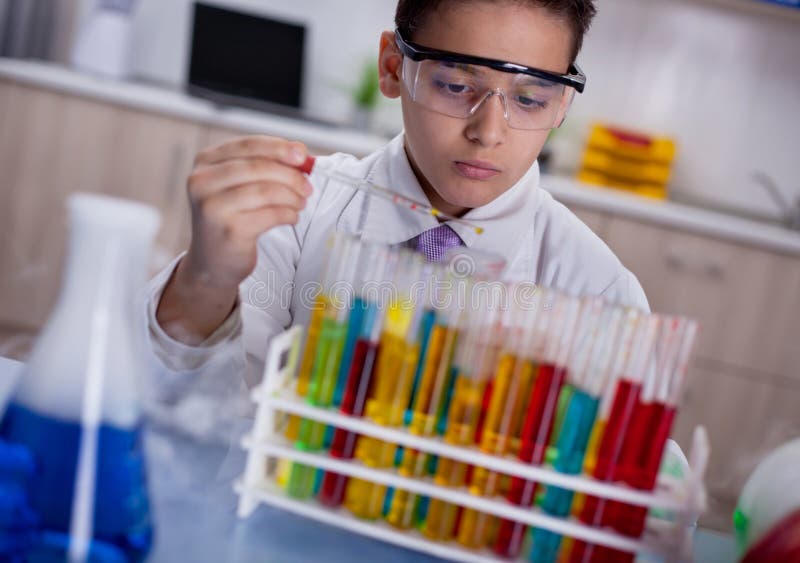 Little schoolboy working in chemistry lab. Little schoolboy working in chemistry lab