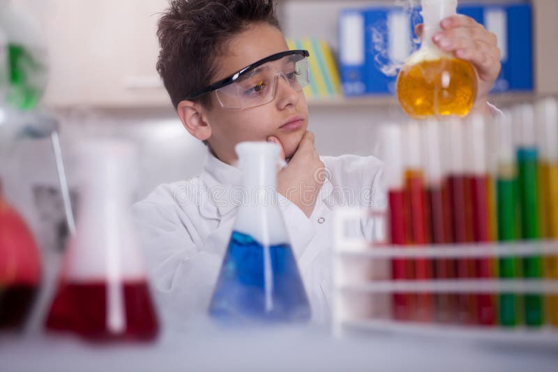 Little schoolboy working in chemistry lab. Little schoolboy working in chemistry lab