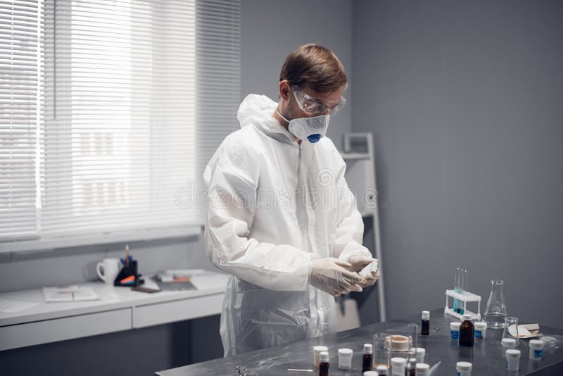 A young scientist studying new substances in lab royalty free stock photos