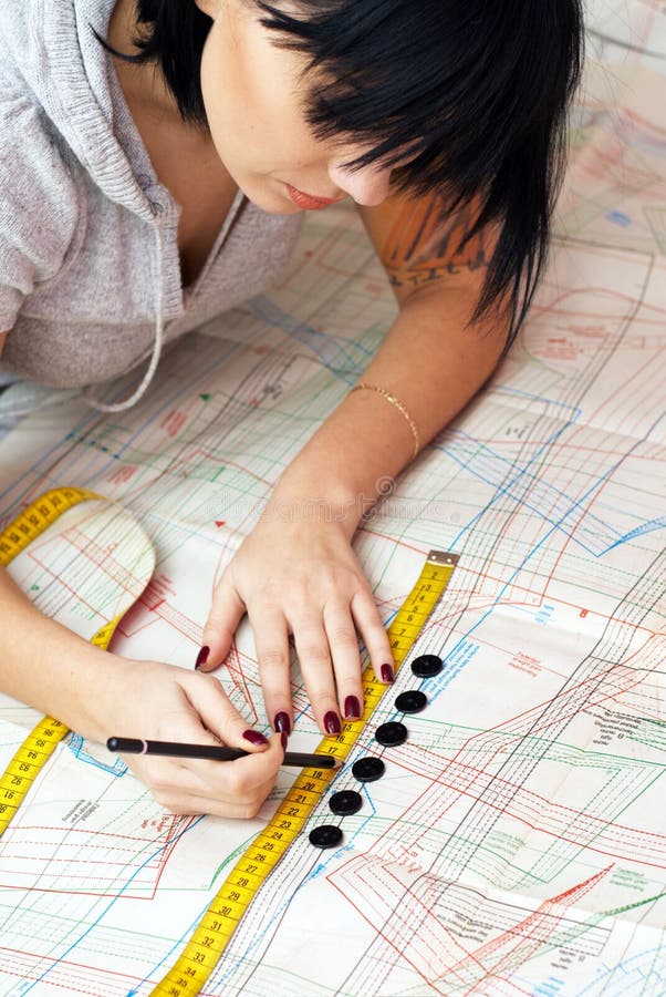 Young seamstress measuring distance