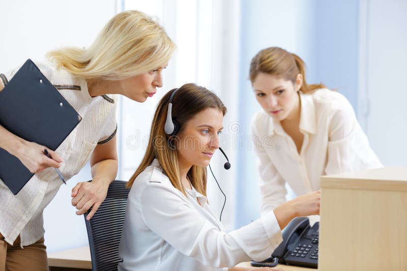 Young secretary in office during training stock photos