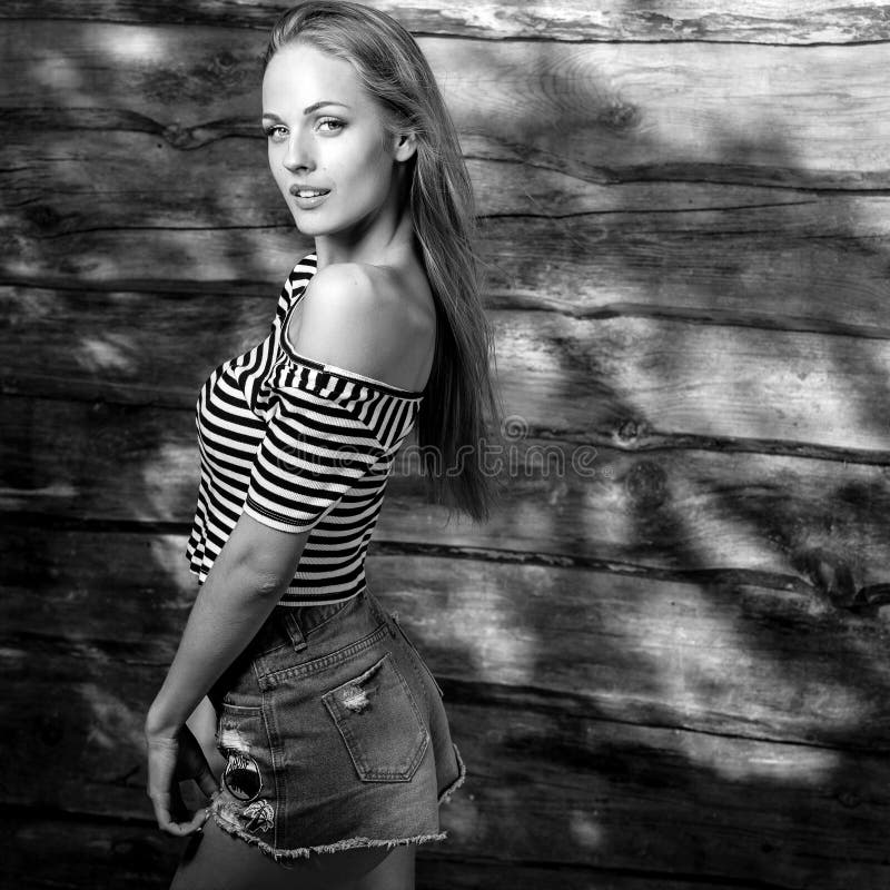 Young sensual & beauty blonde woman pose on wooden background. Black-white photo. stock photos Young sensual & beauty blonde woman pose on wooden background. Black-white photo. stock photos