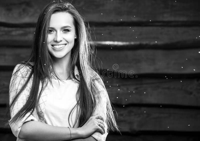 Young sensual & beauty brunette woman pose on wooden background. Black-white photo