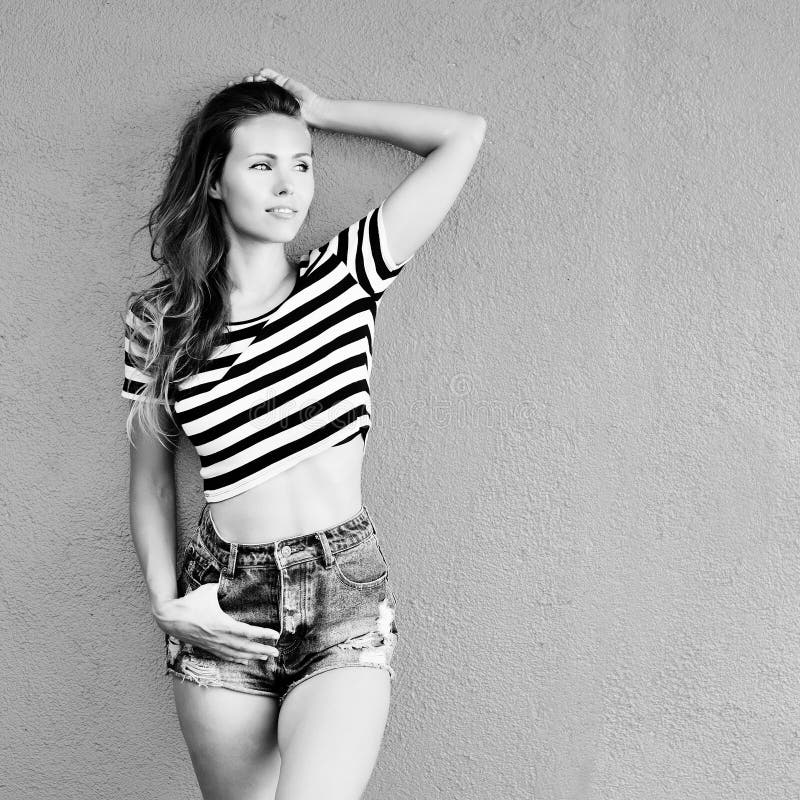 Young sensual model girl pose by the wall. Black-white photo royalty free stock image Young sensual model girl pose by the wall. Black-white photo royalty free stock image