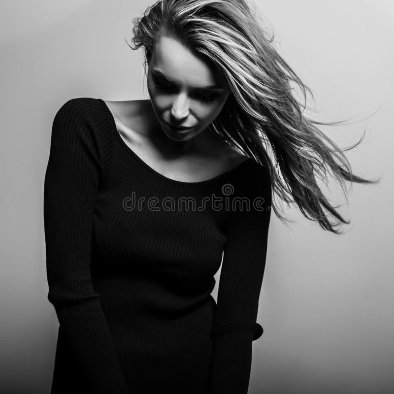 Young sensual model woman pose in studio. Black-white photo.