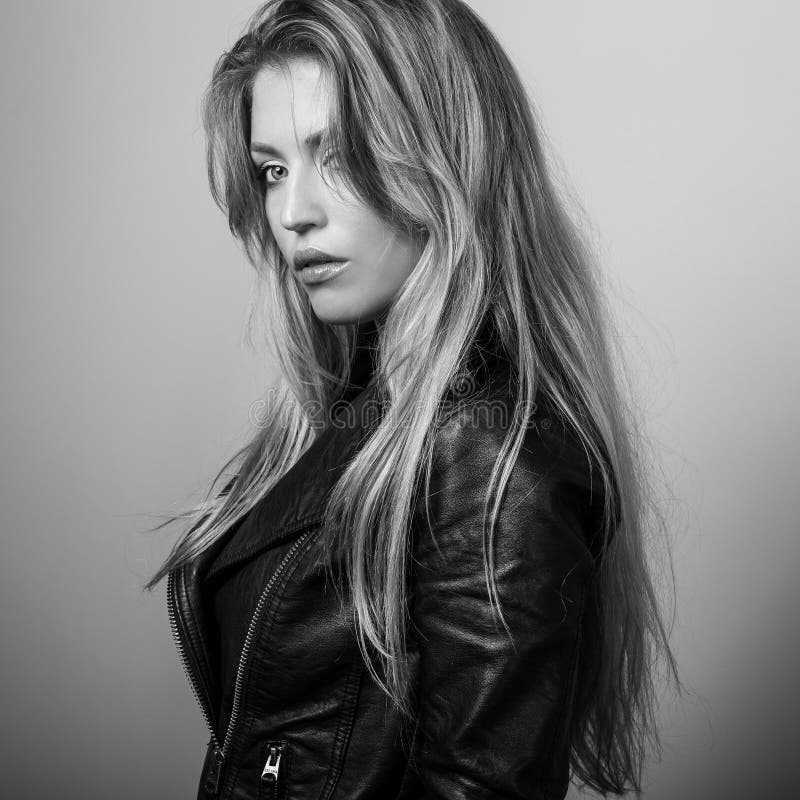 Young sensual model woman pose in studio. Black-white photo.