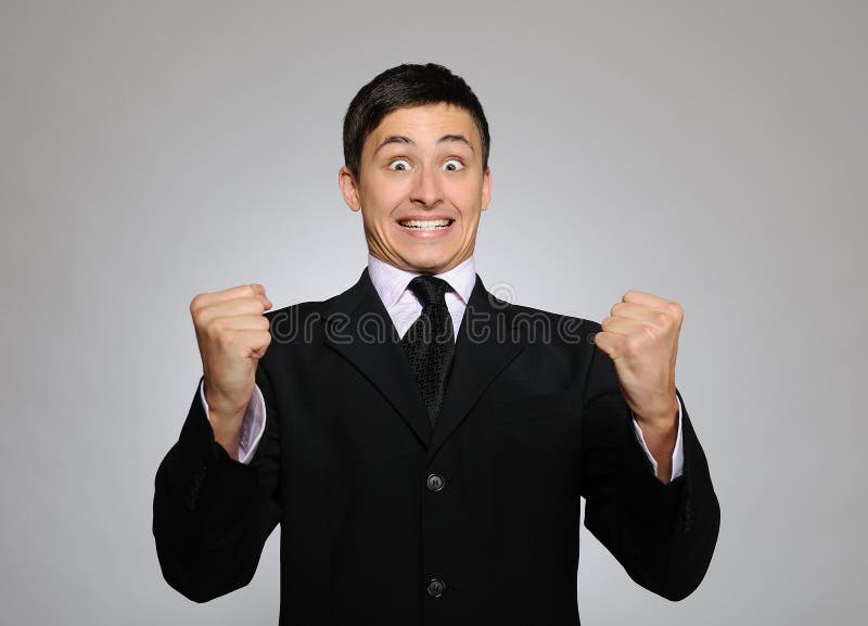 Young serious business man in black suit