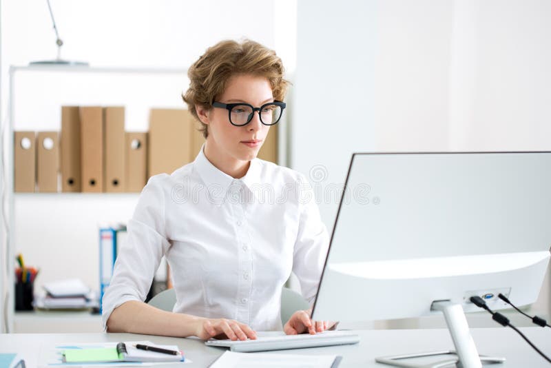 Young serious business woman with computer