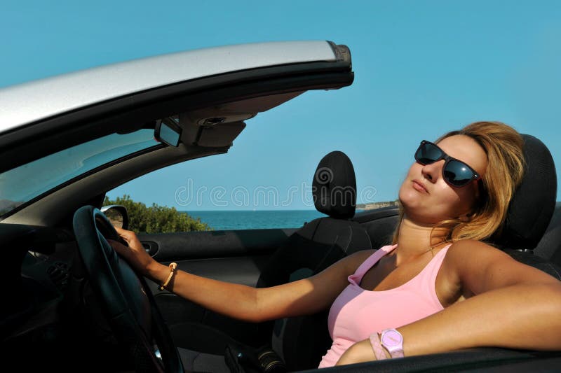 Young chic woman with sunglasses driving cabr