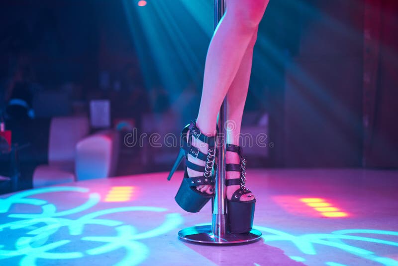 Young Sexy Woman Pole Dancing Striptease With Pylon In Night Club