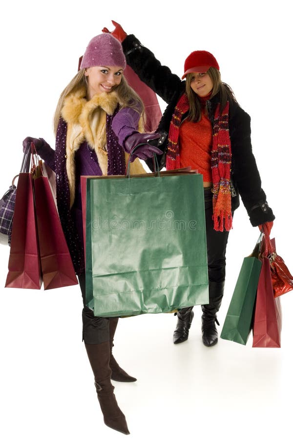 Two happy women with shopping bags. Looking at camera, front view. White background. Two happy women with shopping bags. Looking at camera, front view. White background.