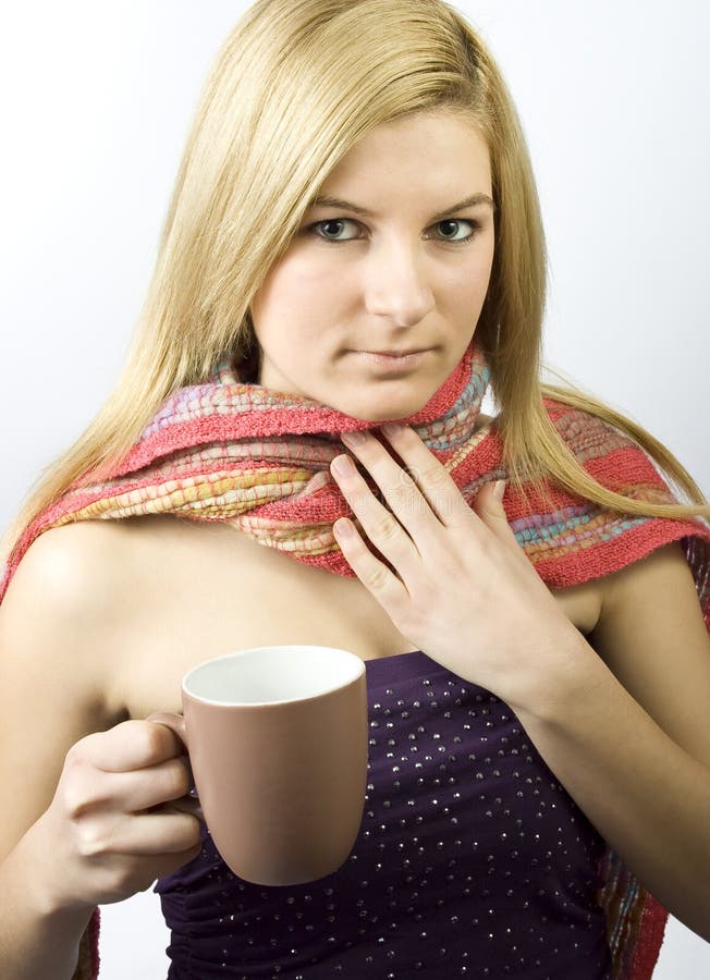 Beautiful caucasian woman in a scarf, drinking tea from a mug. Beautiful caucasian woman in a scarf, drinking tea from a mug.