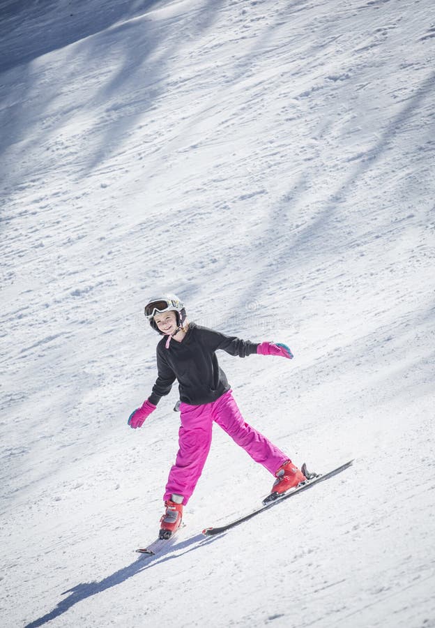 Young skier skiing downhill