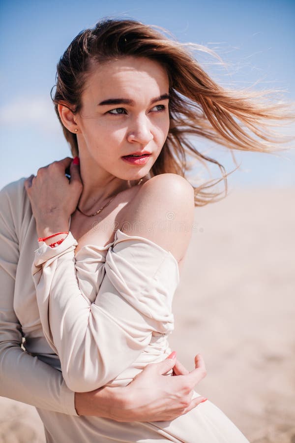 A Young Slender Girl In A Beige Dress Poses In The Wind In The Desert Stock Image Image Of