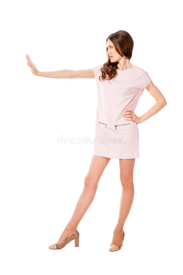 Young slim pretty woman in pink dress posing