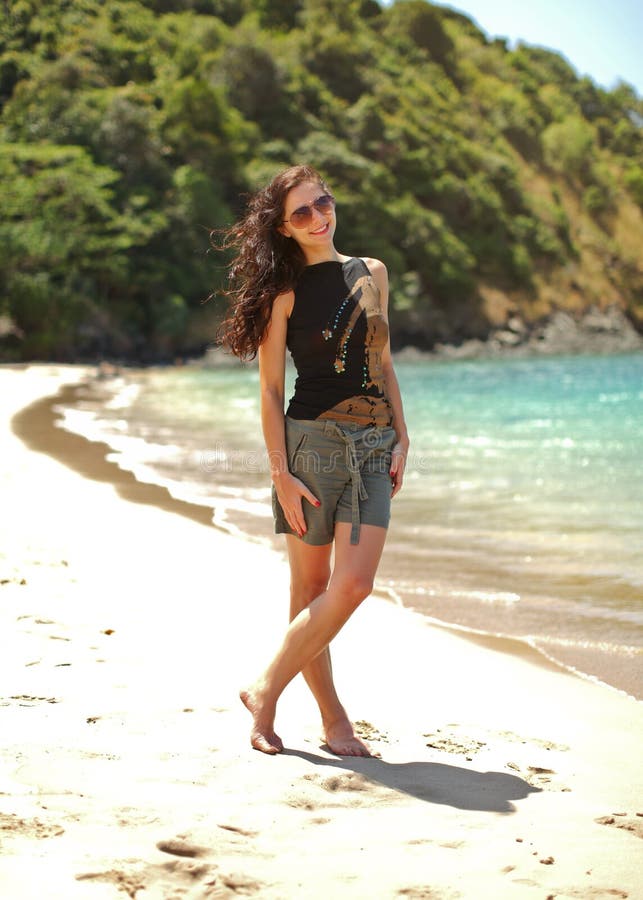 Young slim woman in black t shirt and shorts, wearing sunglasses royalty free stock photo Young slim woman in black t shirt and shorts, wearing sunglasses royalty free stock photo